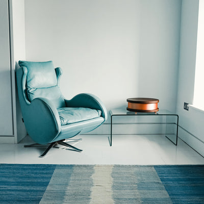 Waveguard Qi Home in Beech on table next to blue chair