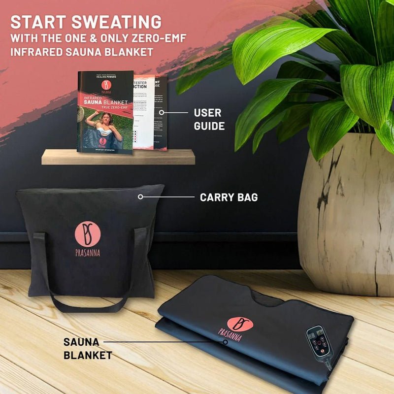 Zero-EMF infrared sauna blanket set with carry bag, user guide, and potted plant on a wooden surface.